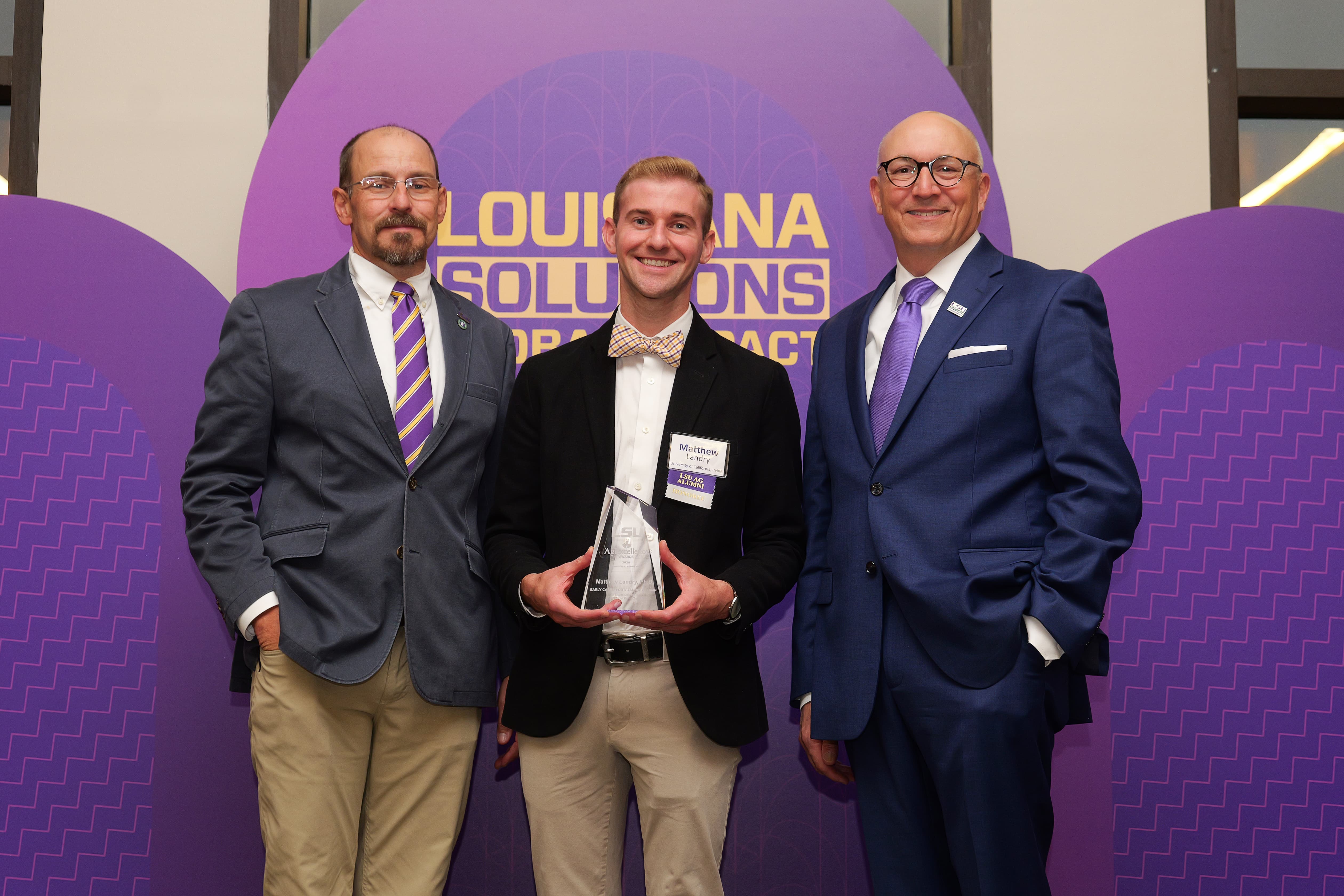 Dr. Matthew Landry receiving award. 