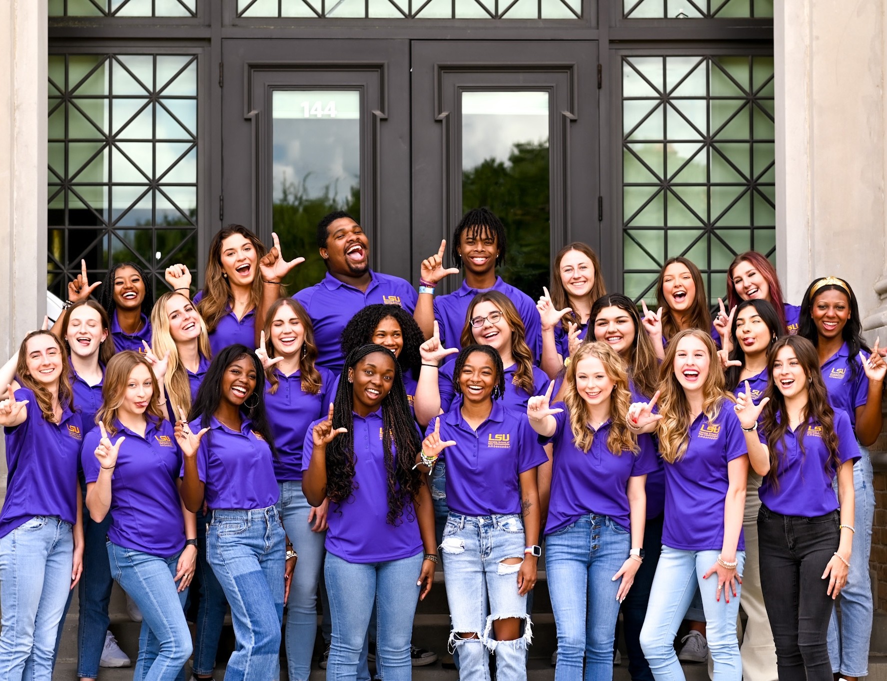 Photo of the Manship Ambassadors posing in front of the Journalism Building
