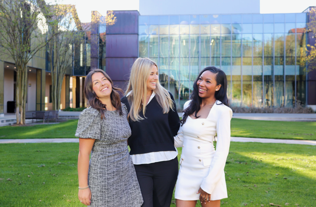 three student government members smiling at a camera three student government members smiling at the camera